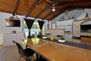 a dining room with a table and a fireplace at Apartment Pag 6412c in Pag