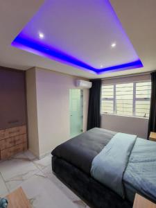 a bedroom with a bed with a blue ceiling at Modern Beachfront Escape in La Mercy in La Mercy