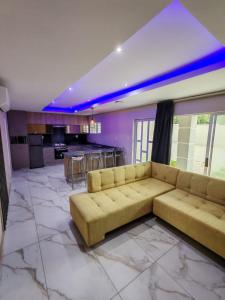 a large living room with a couch and a kitchen at Modern Beachfront Escape in La Mercy in La Mercy