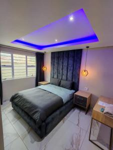 a bedroom with a large bed with a purple ceiling at Modern Beachfront Escape in La Mercy in La Mercy +8 photos