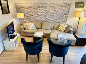 a living room with a couch and two chairs at Lovely Apartment Wassenaar 6P in Wassenaar