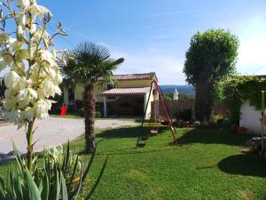 a garden with a swing and a house at Family friendly apartments with a swimming pool Cepic, Central Istria - Sredisnja Istra - 15878 in Kršan