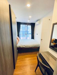 a small room with a bed and a window at The Central Escape Phuket in Ban Rangeng