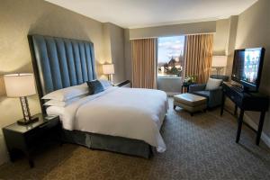 una camera d'albergo con un letto e una televisione di The Marc Hotel a Milwaukee