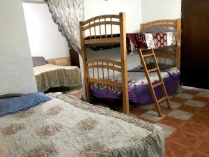 a room with two bunk beds in a room at Rancho el Andariego and La Catrina 