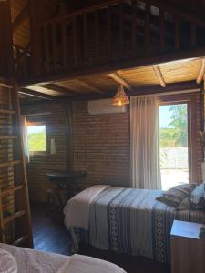 a bedroom with two beds and a window at Sitio Meu Refúgio Paracuru in Paracuru