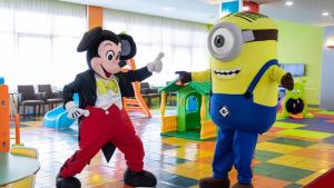 two mascots are standing next to each other in a room at Evenia Olympic Garden in Lloret de Mar +60 photos