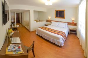 Postel nebo postele na pokoji v ubytování Taypikala Hotel Cusco