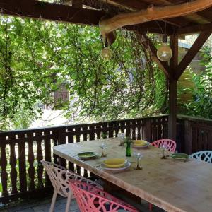 a wooden table and chairs on a wooden deck at Ferienhaus In Atzenhain Mit Großer Terrasse in Mücke