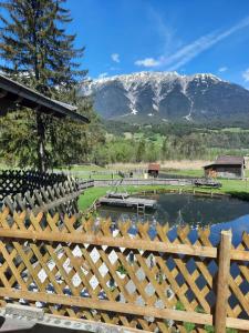 a wooden fence with a view of a mountain at Happis Fassle in Tarrenz