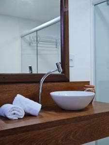 a bathroom sink with a bowl on a wooden counter at FLATS SHALON - MORRO DE SÃO PAULO in Morro de São Paulo