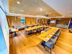 a large dining room with wooden tables and chairs at Hotel Birkenhof in Hanau am Main