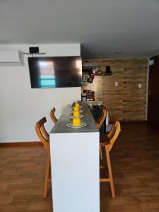 a kitchen with a table with a yellow bowl on it at FLATS SHALON - MORRO DE SÃO PAULO in Morro de São Paulo