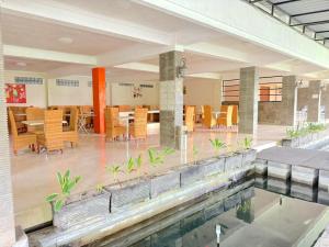 a house with a swimming pool and a dining area at De View Hotel By PRO in Punten