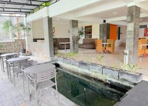 a house with a swimming pool with tables and chairs at De View Hotel By PRO in Punten