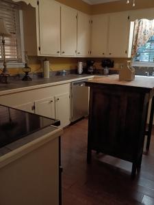 uma cozinha com armários brancos e uma bancada em Waterloo Farms em Hattiesburg