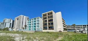 a building on the beach next to some buildings at Viking Motel in Myrtle Beach