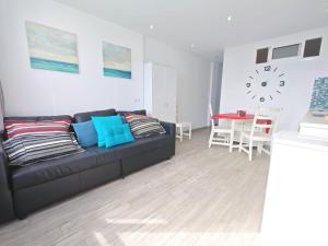 ein Wohnzimmer mit einer schwarzen Couch und einem Tisch in der Unterkunft Los Molinos 503 in San Bartolomé de Tirajana