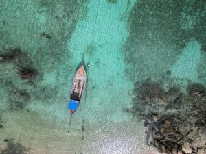 an aerial view of a boat in the ocean at Aya Beach Resort Koh Lipe in Ko Lipe
