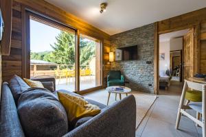 Appartement Haut de Gamme au cœur du village avec terrasse de 34m2 - 6 personnes في سانت سورلين دوارفيز: غرفة معيشة مع أريكة ونافذة كبيرة