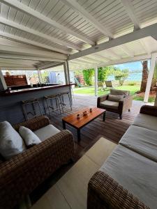 a living room with two couches and a table at Maison bord de mer in Le Gosier