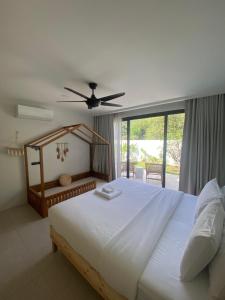 a bedroom with a large white bed and a window at Villa Amour 3 Bedroom Spa Pool Retreat near Beach - Lamai in Amphoe Koh Samui