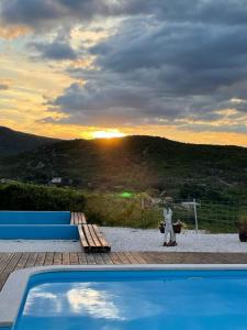 a person standing next to a swimming pool with the sunset at Family friendly house with a swimming pool Donji Dolac, Zagora - 21274 in Dugopolje
