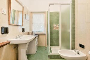 a bathroom with a sink and a shower at La dimora dell'artista sea view free parking in San Terenzo