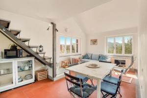 a kitchen and living room with a table and chairs at La dimora dell'artista sea view free parking in San Terenzo