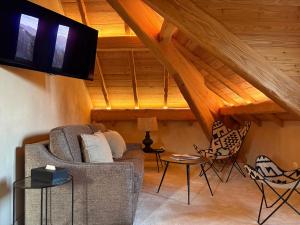 a living room with a couch and two chairs at Hôtel Le Prieuré - Pra Loup 1500 in Pra-Loup