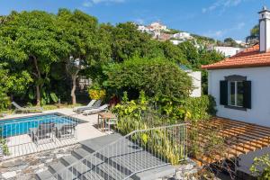 a view of a house with a swimming pool at Casa da Cal - by Casas na Ilha in Câmara de Lobos