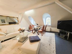 a living room with a white couch and a table at Ostseeloft Wischuer in Rerik