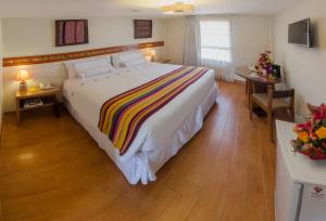 Postel nebo postele na pokoji v ubytování Taypikala Hotel Cusco