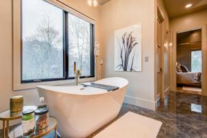 a large bathroom with a tub and large windows at Maynard V at Elk Creek in Banner Elk +59 photos