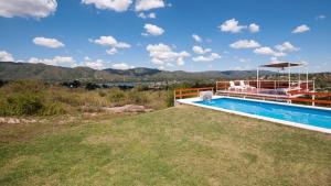 a house with a swimming pool with a view of the water at El Origen in Bialet Massé