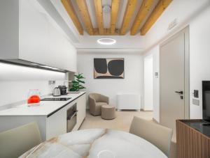 a kitchen and dining room with a table and chairs at Palazzo Degli Eletti R&R in Venice +89 photos