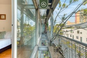 a glass house with a view of the city at Centric 2 BR Condo - Roma - Rio de Janeiro Park in Mexico City