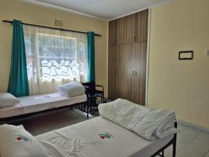 Postel nebo postele na pokoji v ubytování CFC Family Care Home