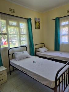 Postel nebo postele na pokoji v ubytování CFC Family Care Home