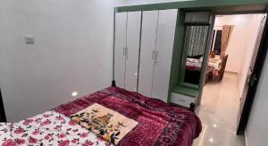 a bedroom with a bed and a large mirror at RR Villa in Bantvāl +3 photos