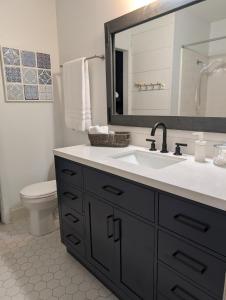 a bathroom with a sink and a toilet and a mirror at Wilmington Family Vacation Home in Wilmington +25 photos