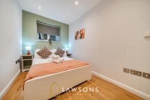 a bedroom with a bed with two stuffed animals on it at 2BR House, Walk to Windsor Castle, Parking for 2 in Windsor