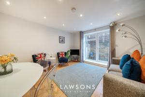 a living room with a couch and a table at 2BR House, Walk to Windsor Castle, Parking for 2 in Windsor