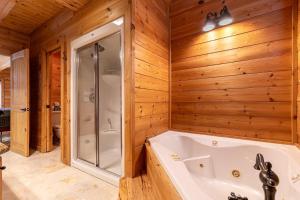 a bathroom with a tub and a shower at Whiskey Bear Escape in Fleetwood +32 photos