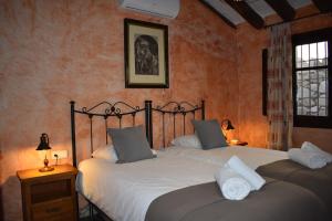 a bedroom with two twin beds with white pillows at Finca Higueron with private Pool in Río +37 photos