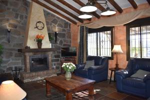 a living room with couches and a fireplace at Finca Higueron with private Pool in Río
