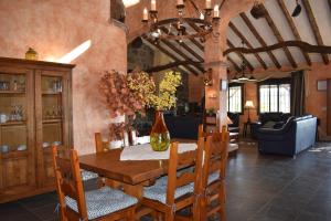 a dining room with a wooden table and chairs at Finca Higueron with private Pool in Río