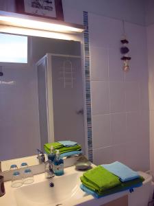 a bathroom with a sink and a mirror at Chambre d'hôtes - Le quartier haut in Sète