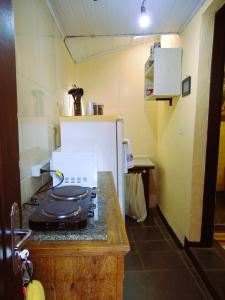 a kitchen with a stove top oven in a room at Vila Secreta in Campos do Jordão +22 photos