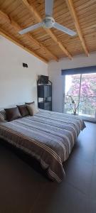 a large bed in a room with a large window at Loft Moderno in Viedma